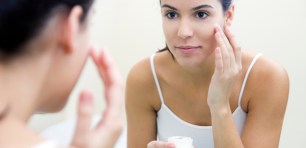 Woman applying skincare product