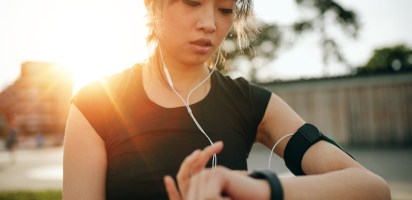 Woman using her fitness tracker while exercising; wearable technology