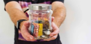 hands-holding-out-jar-of-money