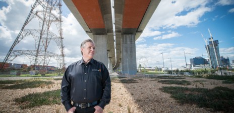 Grant Petty, Blackmagic Design founder standing under bridge looking into the distance