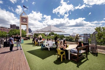 Wisr staff working on the balcony in Sydney. Image: supplied. 