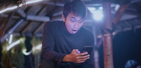 shocked man looking at phone